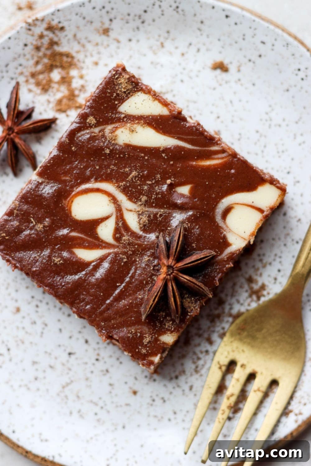 A single slice of chocolate chai Greek yogurt cheesecake bar, perfectly swirled and garnished, presented beautifully on a plate.