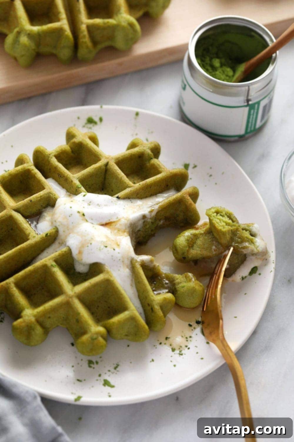 A beautifully arranged stack of vibrant green matcha waffles, ready to be served.