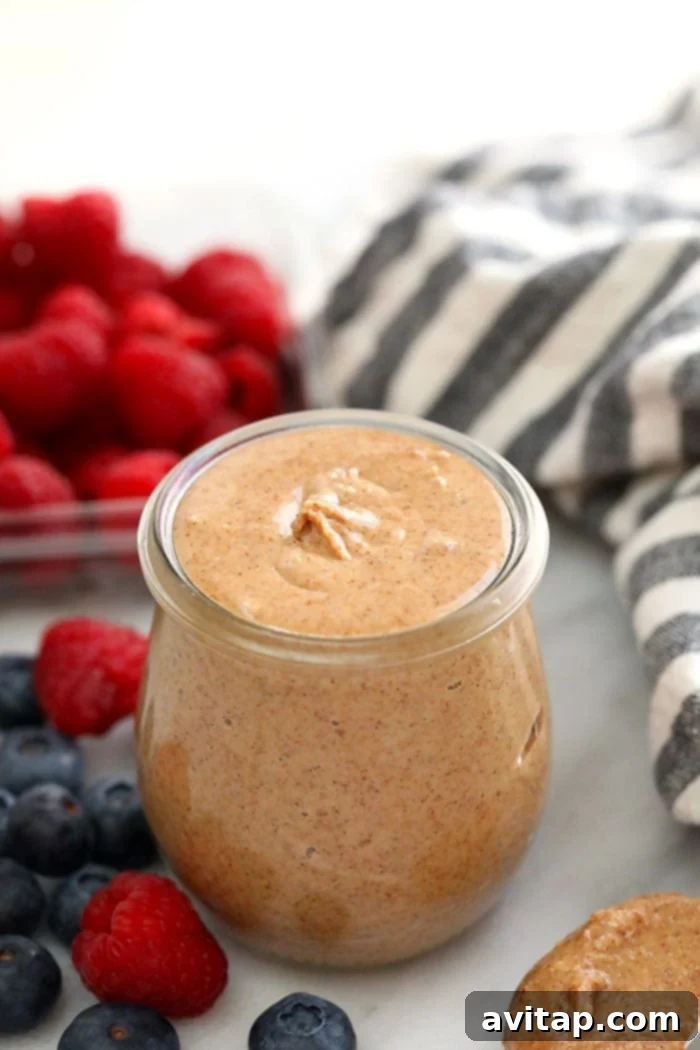 Jar of homemade vanilla bean almond butter, showcasing its creamy texture.