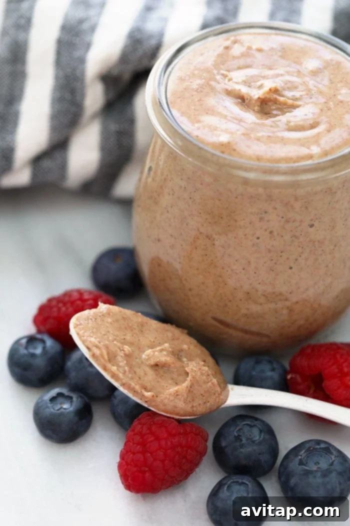 Close-up of vanilla bean almond butter in a glass jar, ready to be enjoyed.