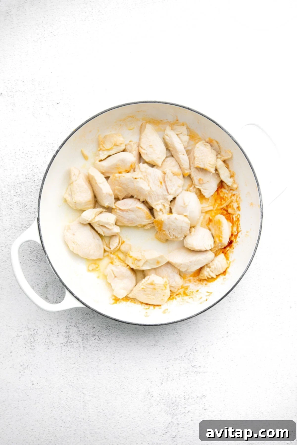 Perfectly Cooked Chicken: Foundation of Your Kung Pao Close-up of diced chicken breast being cooked in a pan, lightly seasoned.