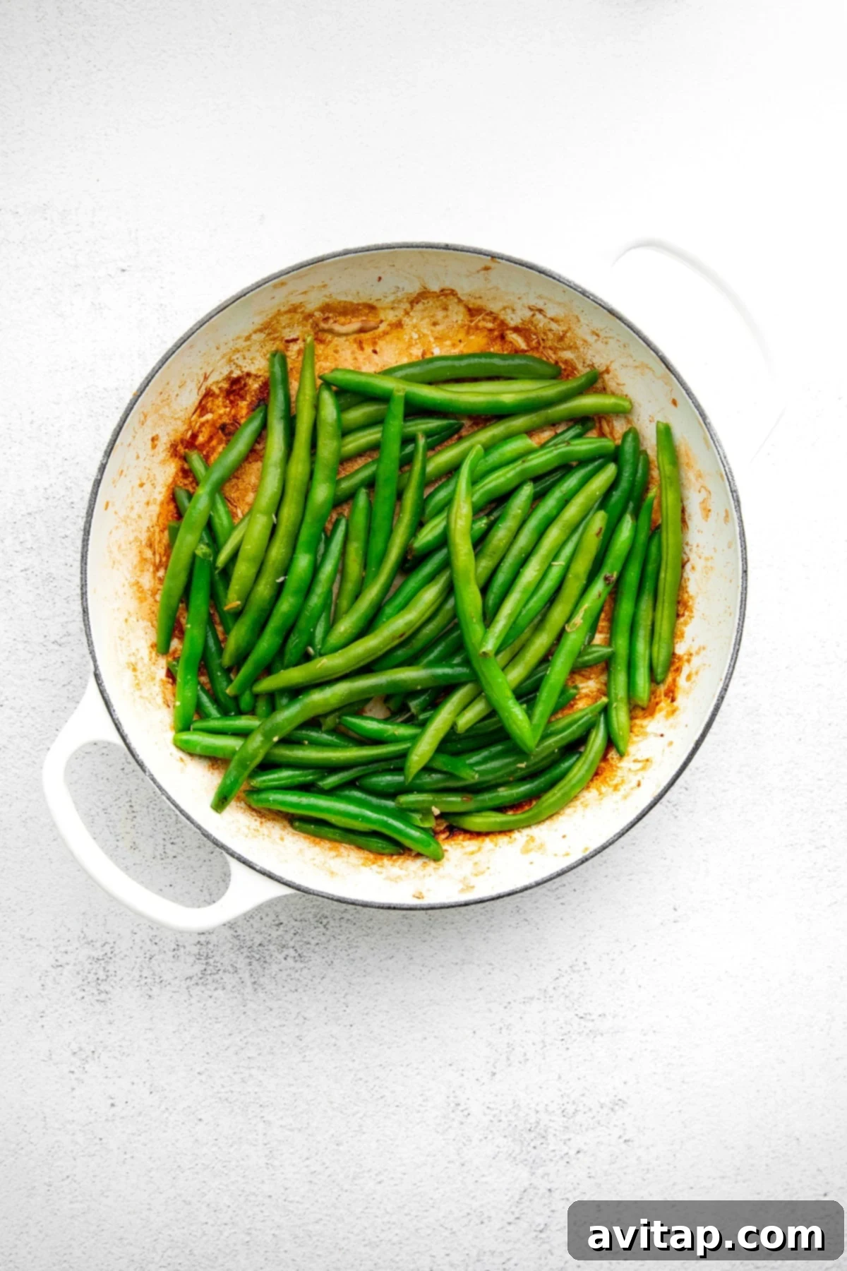Crisp Green Beans for Your Healthy Stir-Fry Fresh green beans being stir-fried in a pan, a vibrant addition to any meal.