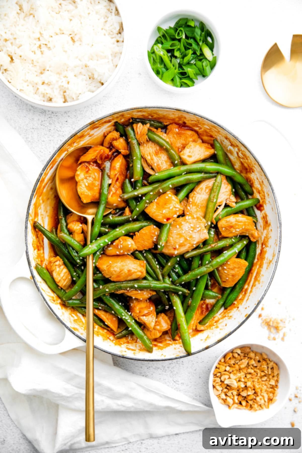 Kung Pao Chicken: A Visual Feast, Ready for Serving A large pan filled with freshly prepared Kung Pao Chicken and green beans, garnished with sesame seeds.