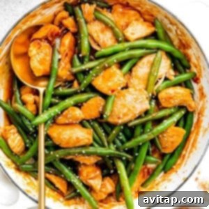 Weeknight Kung Pao Chicken 3 Kung Pao Chicken and green beans in a pan with sesame seeds.