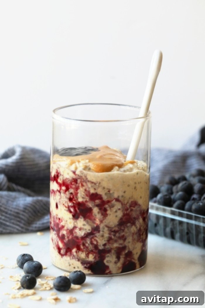 Jar of delicious PB and J overnight oats, ready to eat