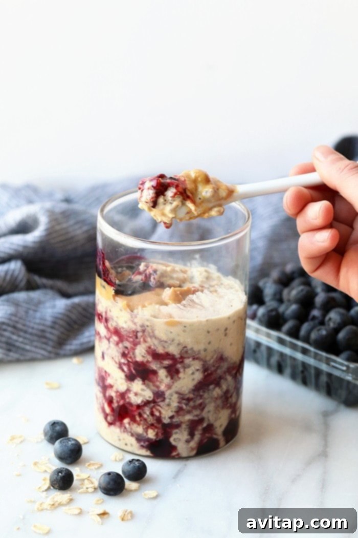 Another jar of PB and J overnight oats, beautifully layered and ready for a healthy breakfast.