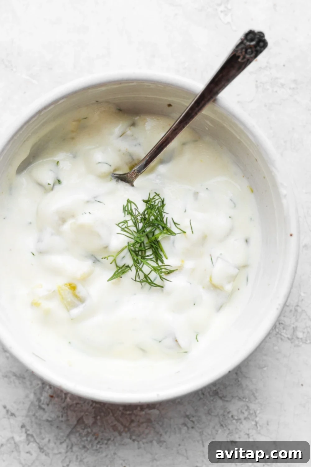 dill pickle dip in bowl with spoon