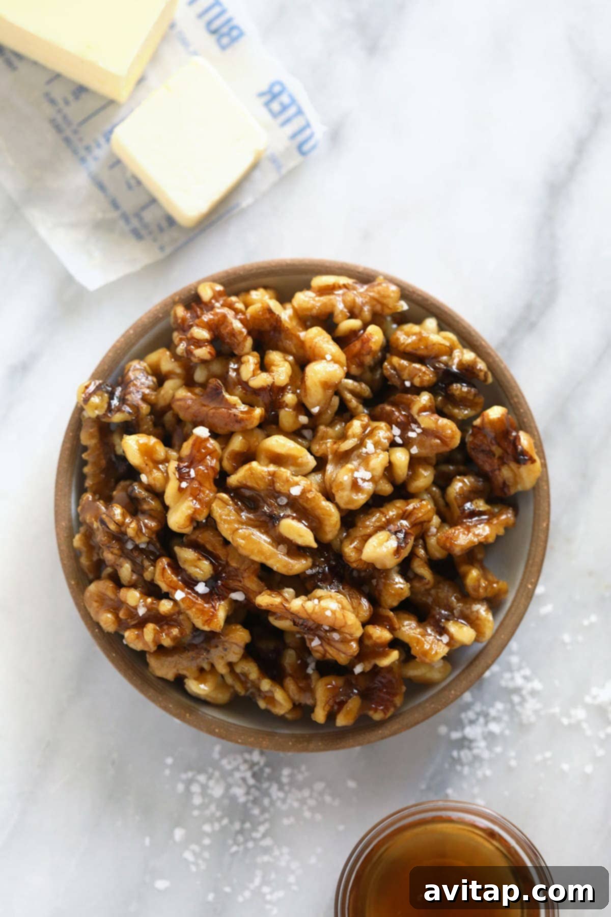Simply Delicious Candied Walnuts 2 A bowl filled with golden brown candied walnuts, ready to be enjoyed as a delicious snack or elegant salad topping.