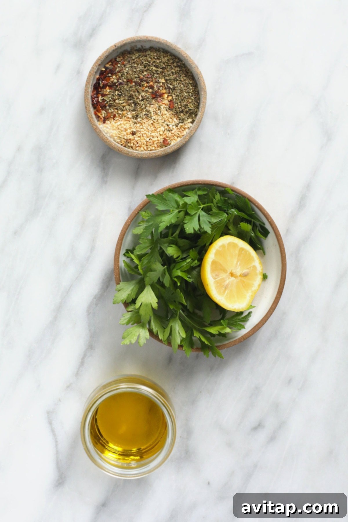 All the fresh ingredients for the Italian chicken marinade laid out on a kitchen countertop.