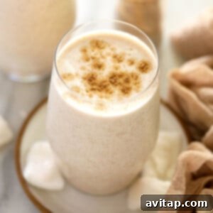 Close-up of a glass of Coconut Chai Protein Shake, garnished with a sprinkle of chai spice.