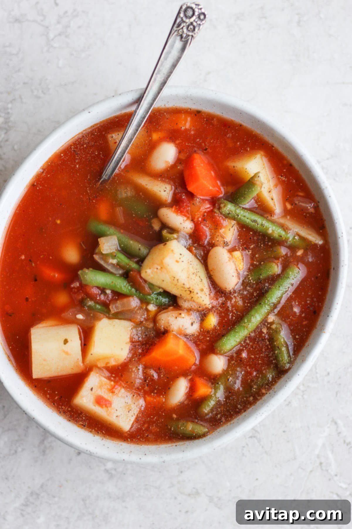 A single bowl of beautifully prepared hearty vegetable soup, ready to be enjoyed as a comforting and healthy meal.