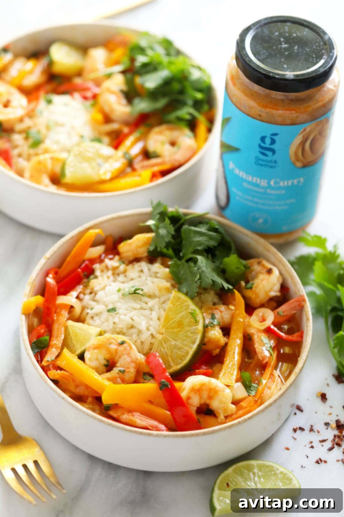 Quick and Creamy Panang Shrimp 6 A vibrant and appetizing bowl of Shrimp Panang curry, garnished with fresh cilantro and a lime wedge, ready to be savored.