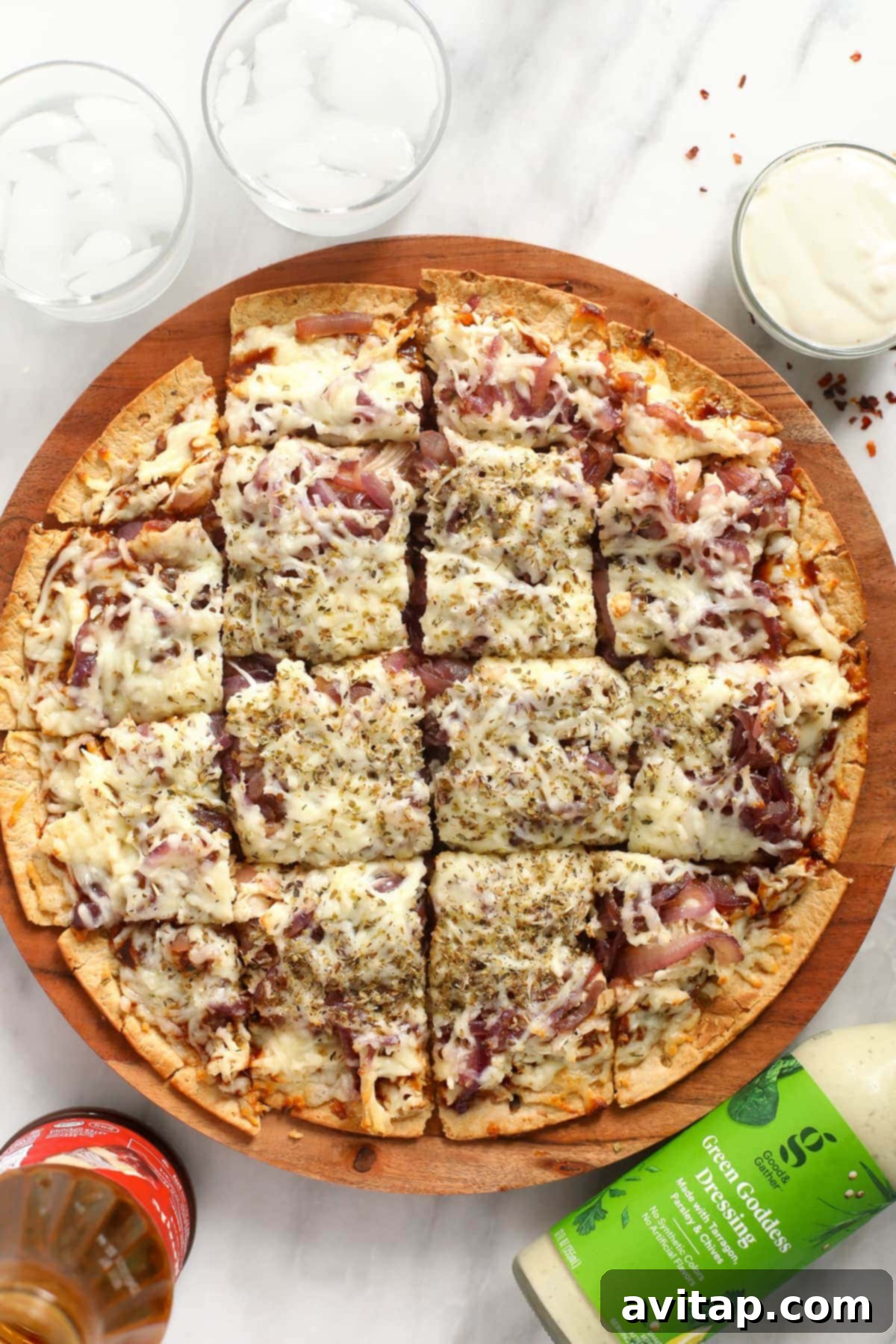 Sweet & Smoky BBQ Chicken Pizza 6 Sliced BBQ chicken pizza with caramelized onions, garnished with fresh herbs, presented as a perfect shareable meal.
