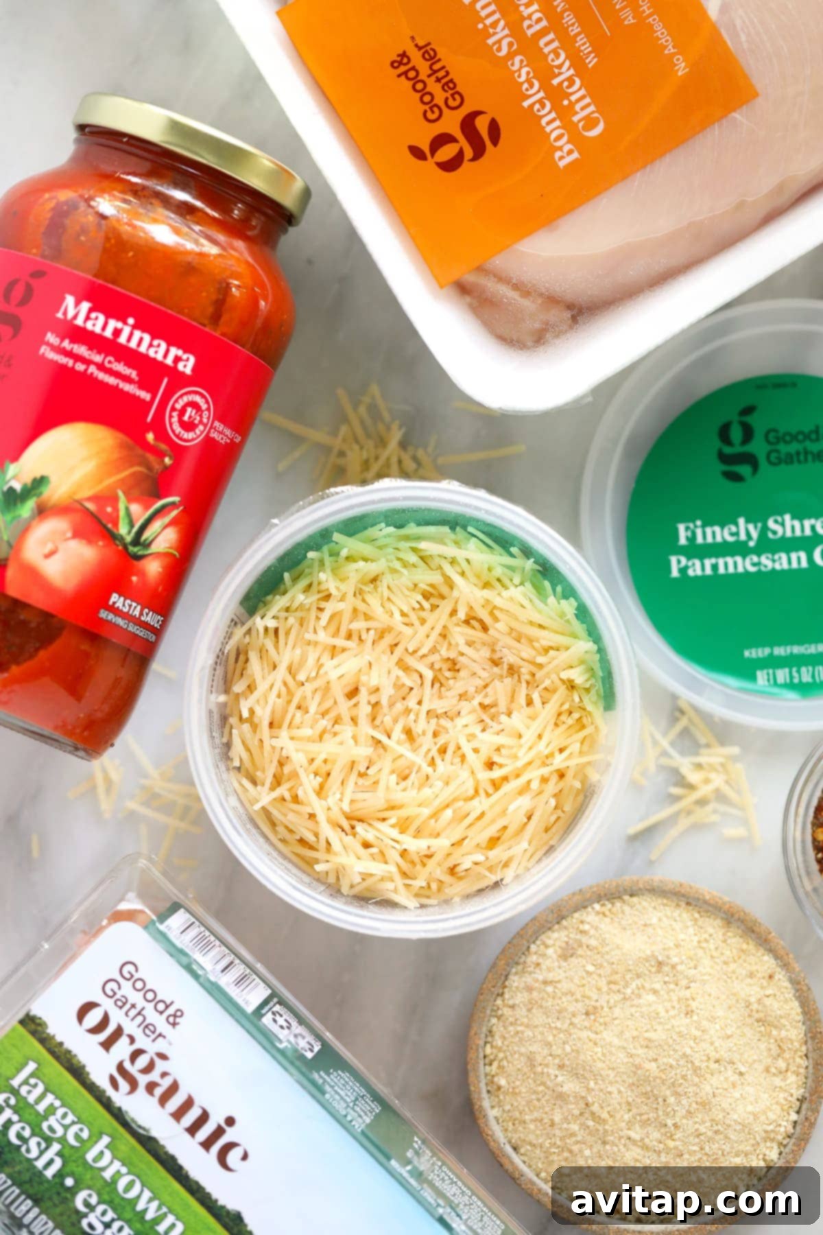 chicken parm ingredients - parmesan cheese, marinara sauce, and chicken breast