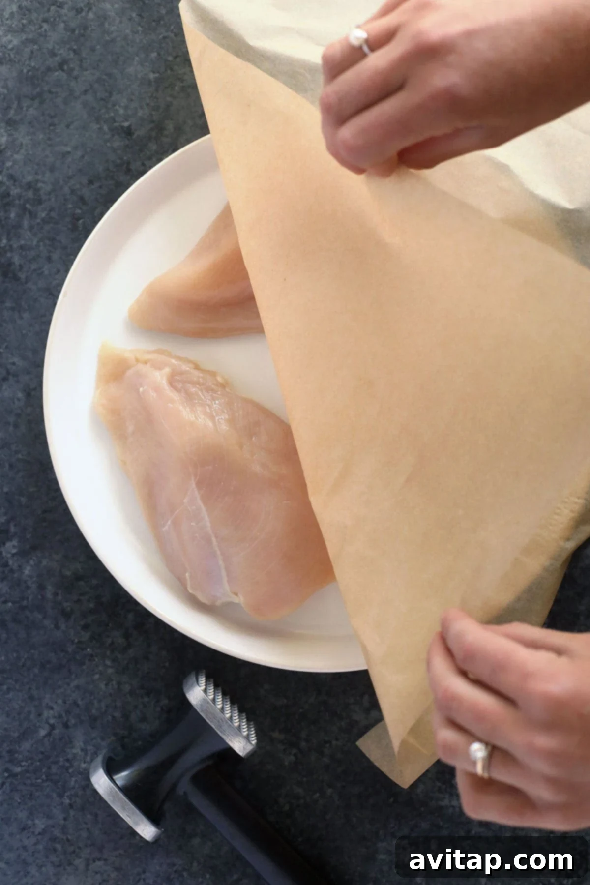 Succulent Pan-Seared Chicken 2 Tenderized chicken breast, prepped and ready for seasoning, highlighting its even thickness for consistent cooking.