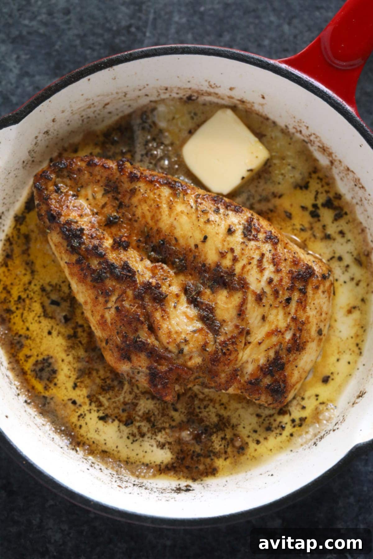 Make this flavorful stovetop chicken breast recipe and pair it with your favorite veggie and grain to complete your meal! Golden-brown pan-fried chicken breast sizzling in a hot pan, demonstrating a perfect sear.