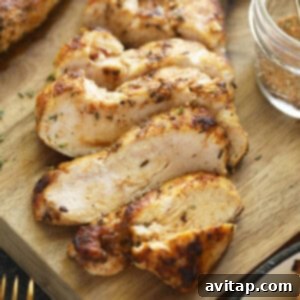 Sliced chicken breast on cutting board, showcasing its juicy interior and golden-brown sear.