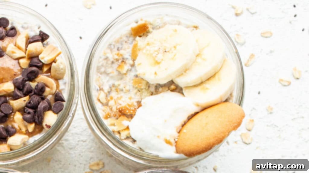Two jars of banana cream pie overnight oats, garnished with banana slices, nuts, and a swirl of whipped cream.