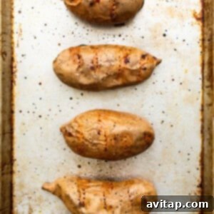 Grilled sweet potatoes on a baking sheet.