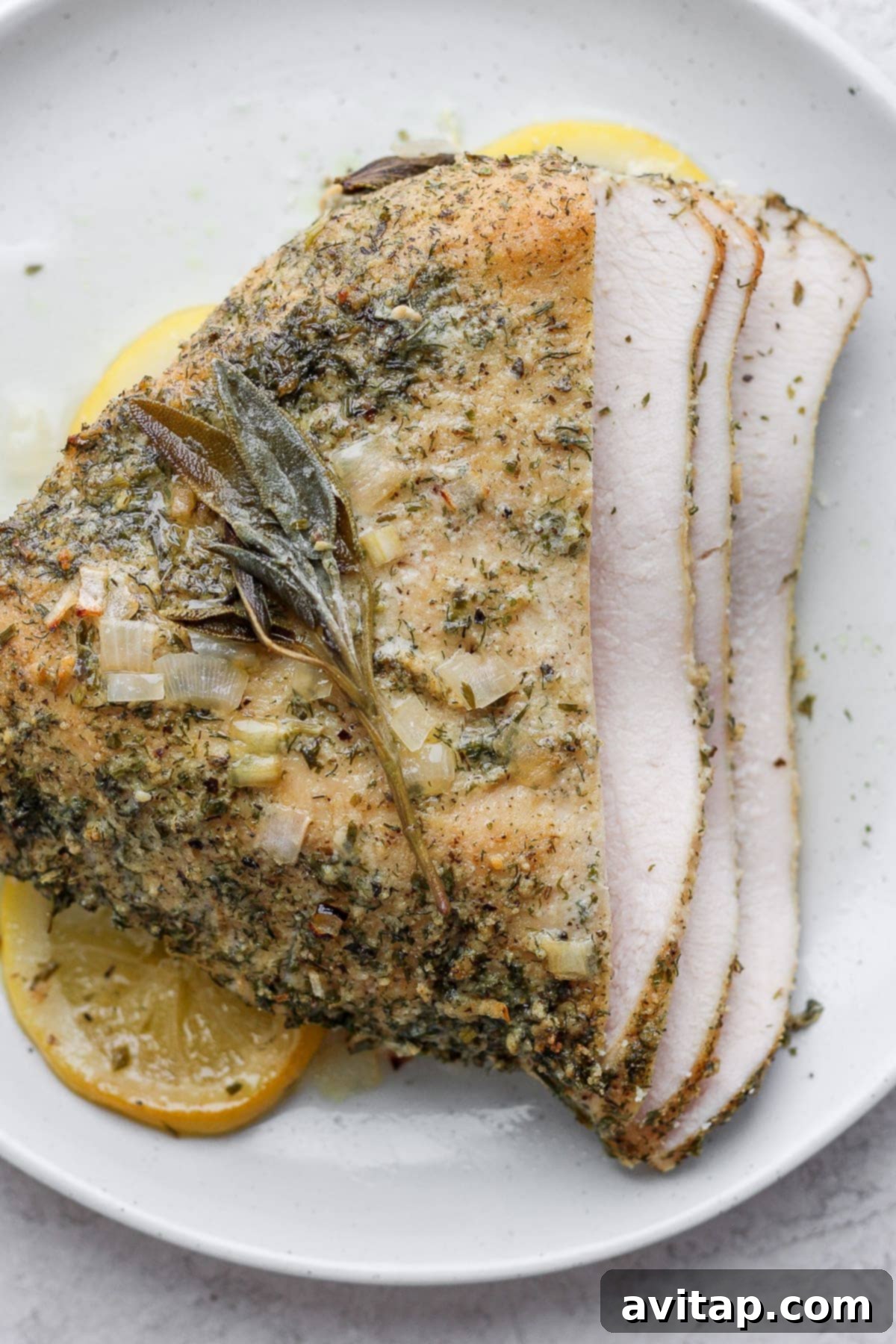 Beautifully sliced roasted turkey breast on a platter, ready to serve.