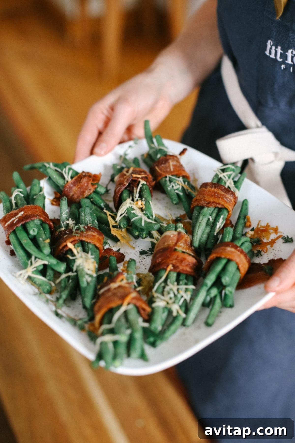 A final shot of bacon wrapped green beans beautifully presented on a plate