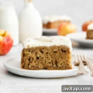 Guilt-Free Cream Cheese Frosting 3 A beautifully frosted apple cake slice with healthy cream cheese frosting, garnished with a sprinkle of cinnamon.