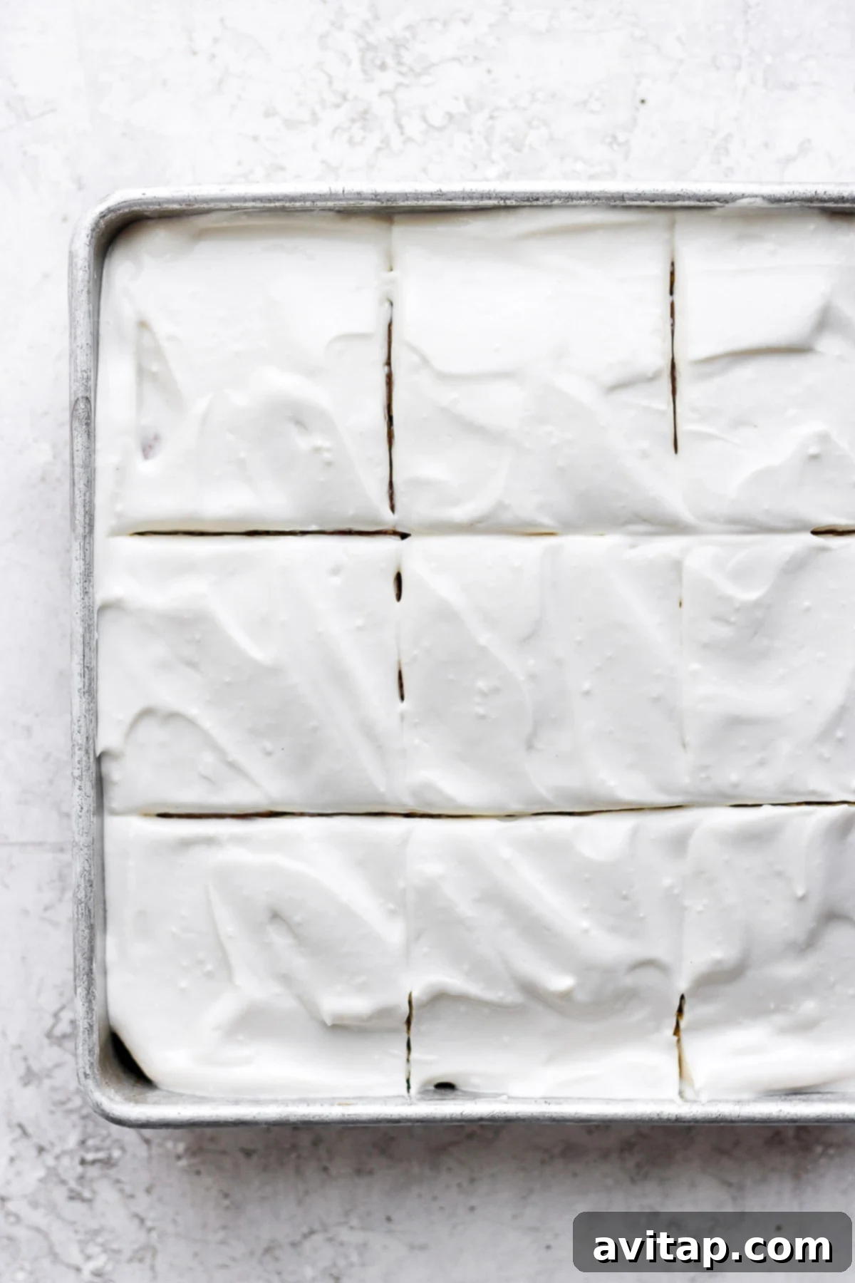 Enjoying a slice of pumpkin cake with healthy cream cheese frosting A generous slice of pumpkin cake, beautifully frosted with healthy Greek yogurt cream cheese frosting, on a simple white plate.
