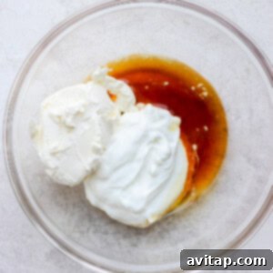All of the ingredients for cream cheese frosting in a bowl.