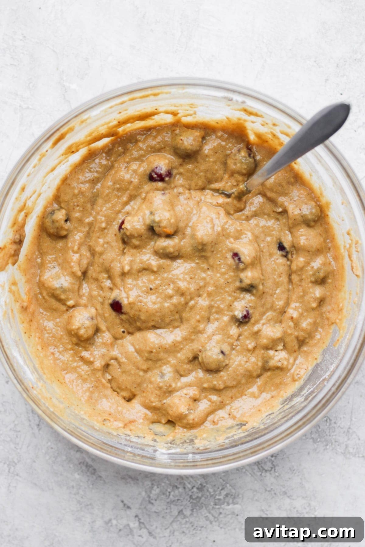 Mixed cranberry orange bread batter in a bowl, ready for baking.