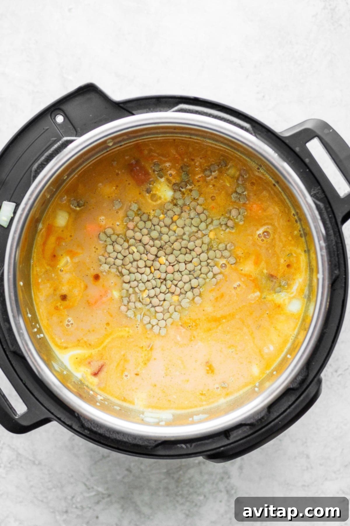 Hearty Instant Pot Lentil Soup 4 All the vibrant ingredients for lentil soup, including spices and vegetables, combined in the Instant Pot before cooking.