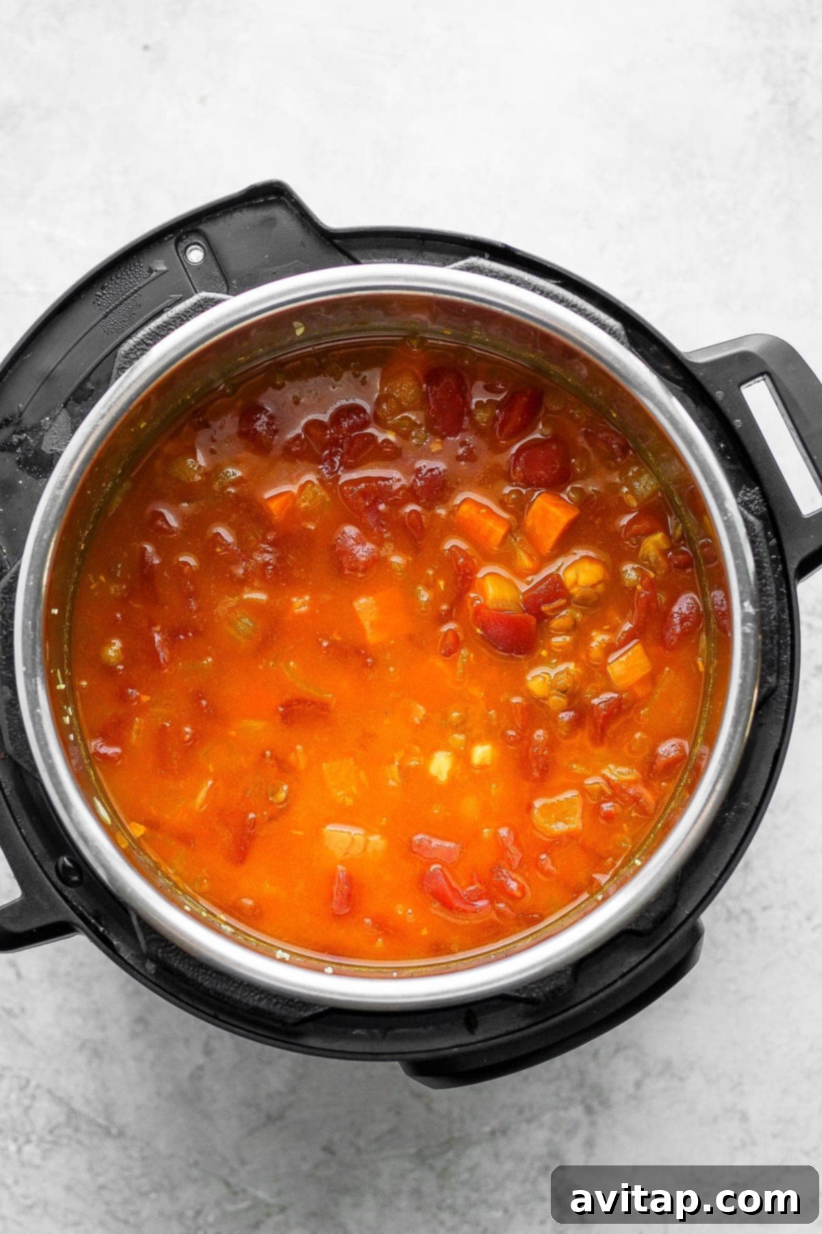 Hearty Instant Pot Lentil Soup 5 Perfectly cooked Instant Pot Lentil Soup inside the Instant Pot, with the lid removed and ready for the final additions.