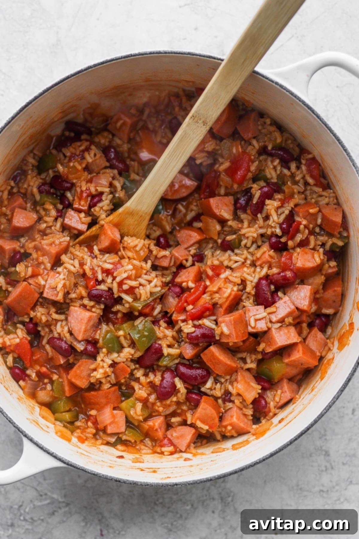 A vibrant pot of easy red beans and rice with savory andouille sausage, ready to be served from a Dutch oven.