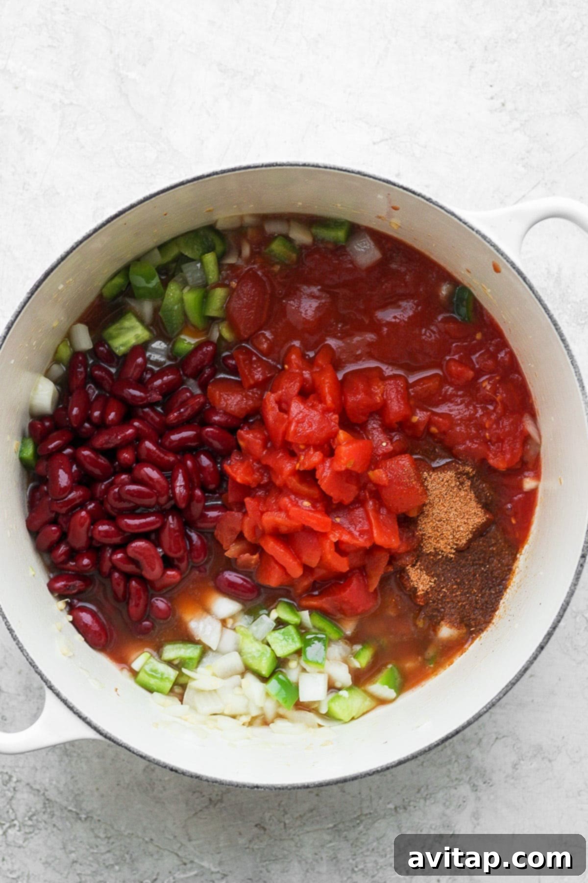 All the delicious ingredients for red beans and rice simmering together in a stock pot, creating a rich and aromatic stew.