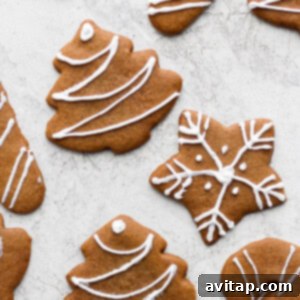 Decorated gingerbread cookies adorned with white icing and colorful sprinkles.