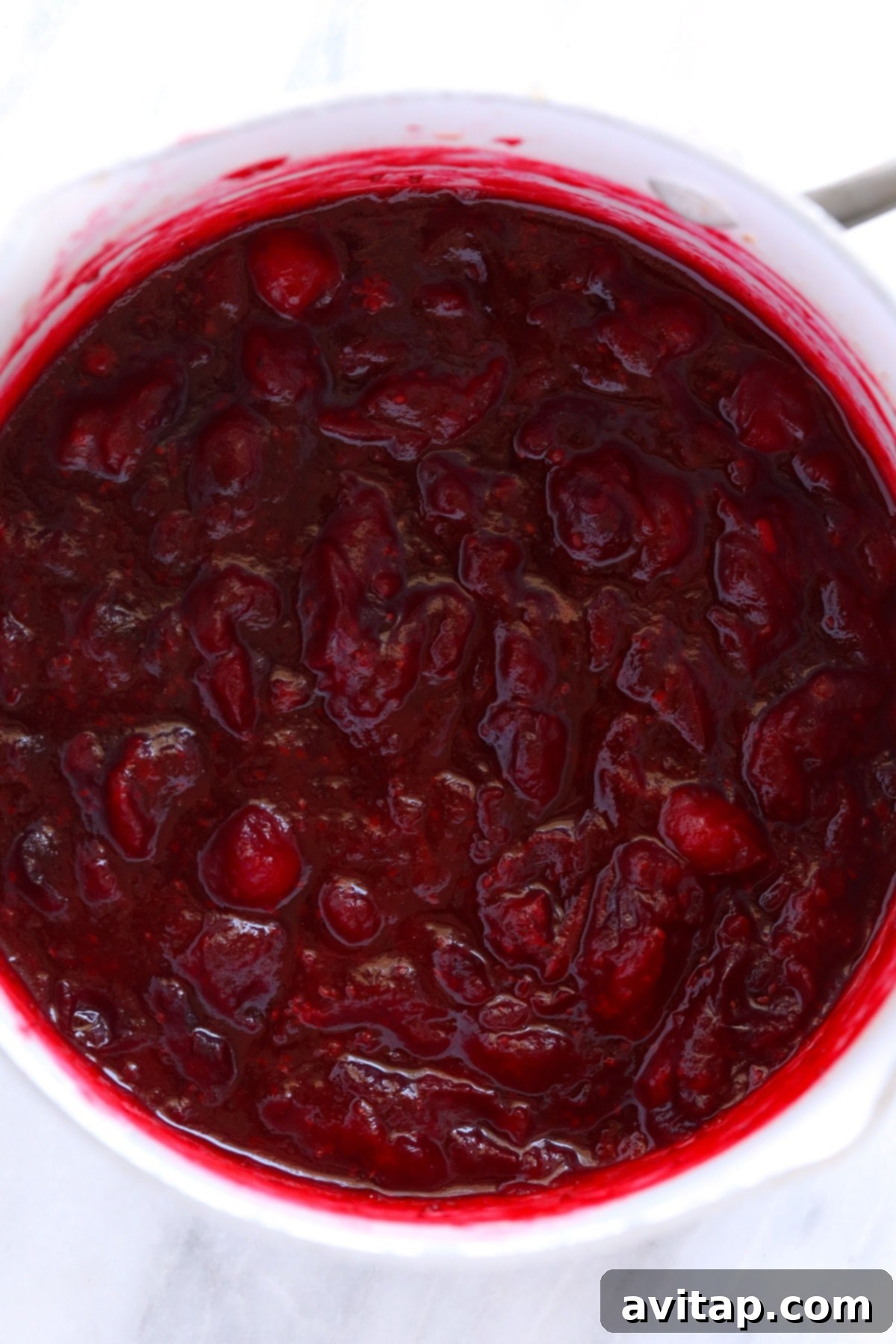 Cooked lemon ginger cranberry sauce in a pot, showing its thick and luscious texture.