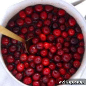All ingredients for cranberry sauce added to a medium saucepan.