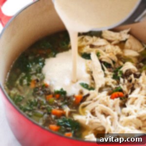 Creamy Chicken Wild Rice Delight 6 a bowl of chicken wild rice soup being poured.