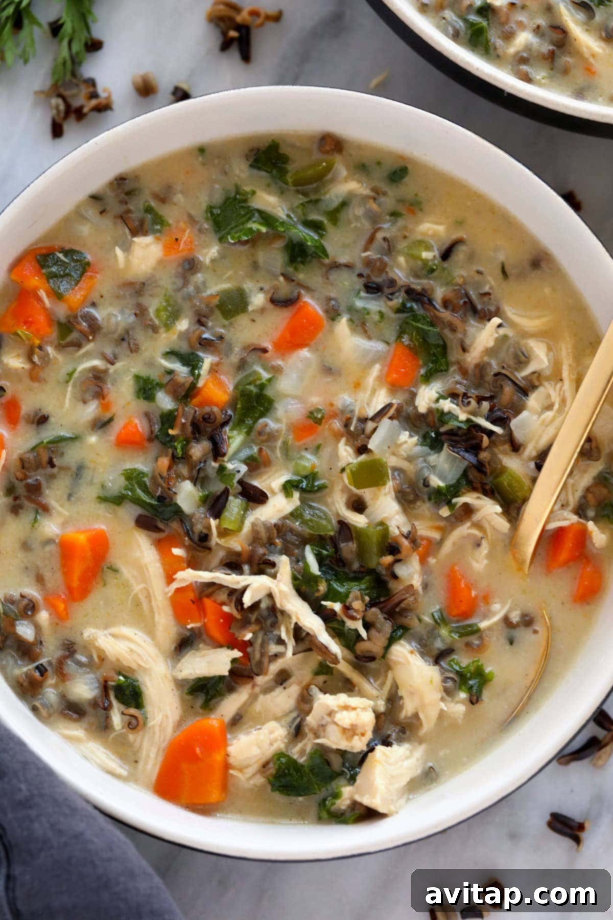 A beautifully presented bowl of creamy chicken wild rice soup, ready for a comforting meal.