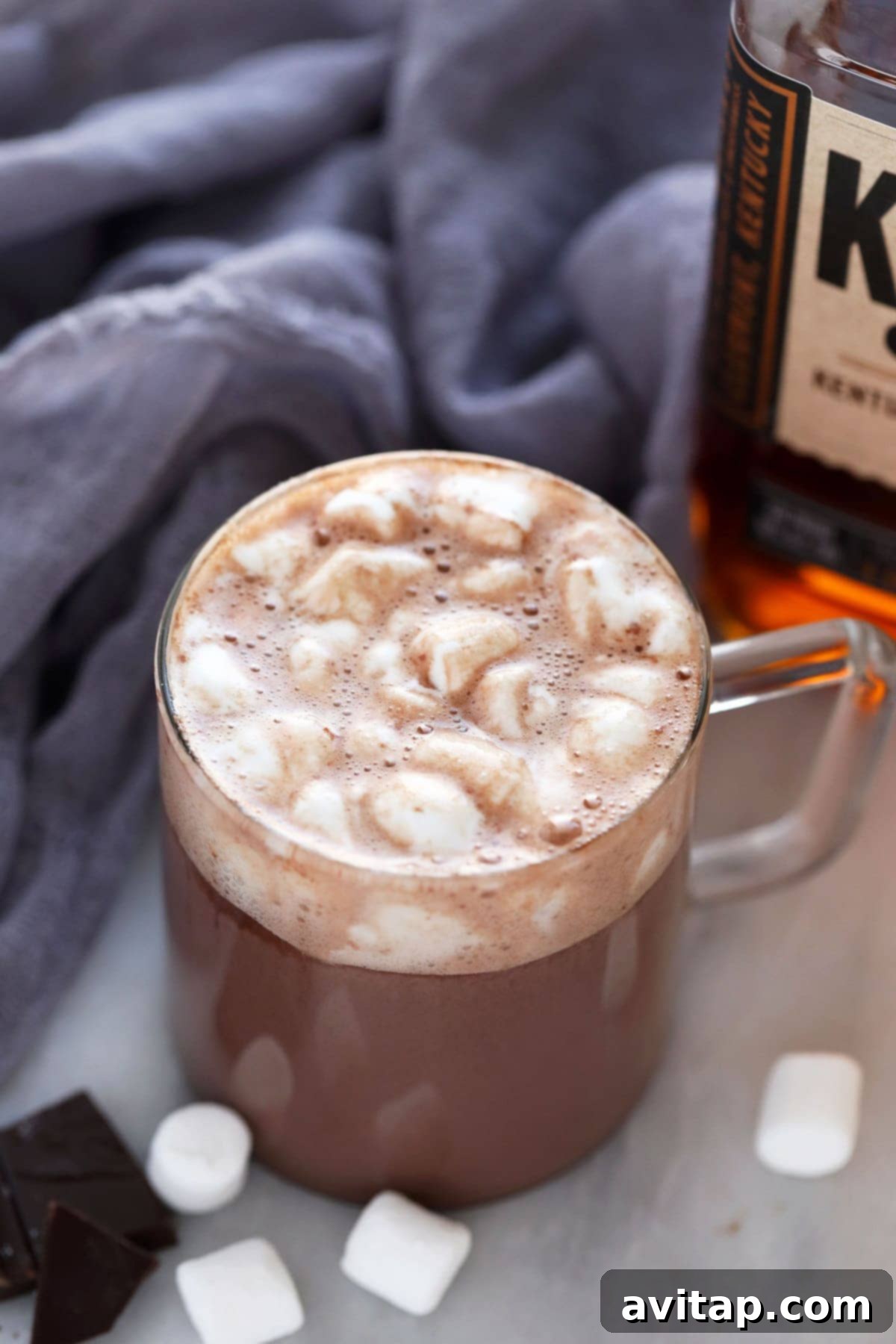 A mug of easy spiked hot chocolate topped with mini marshmallows, ready to be enjoyed.