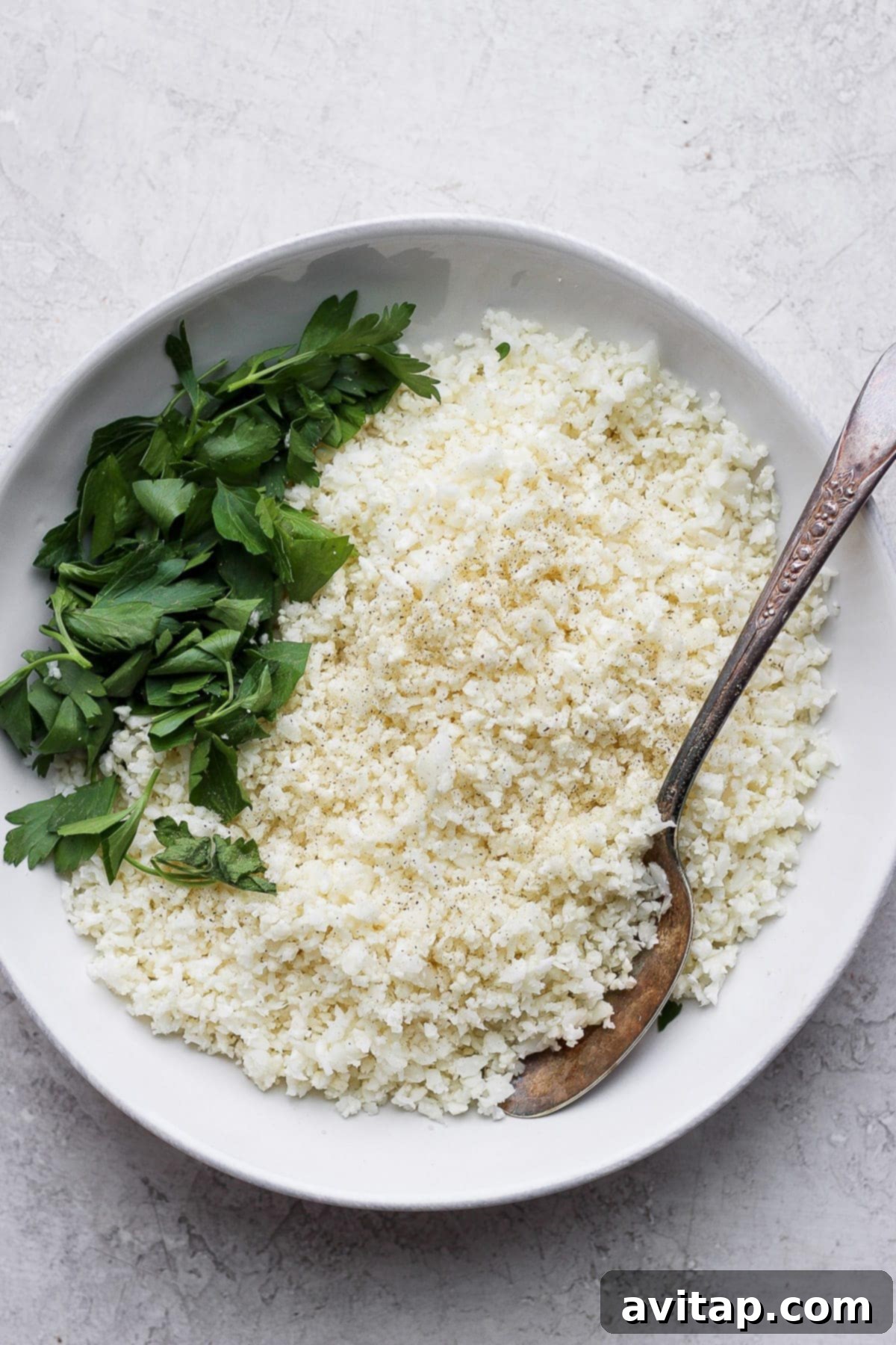 Cauliflower rice in a bowl, ready to be served.