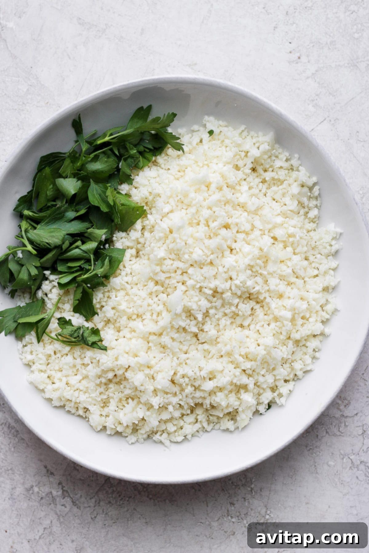 A bowl of fresh cauliflower rice, highlighting its versatility and healthy appeal.