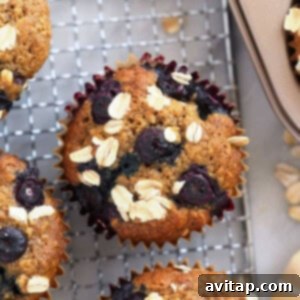 Freshly baked blueberry oatmeal muffins cooling on a rack, showcasing their delicious appearance.