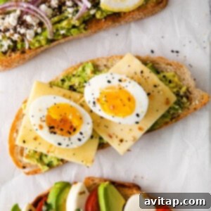 Avocado toast topped with a perfectly cooked egg and various seasonings.