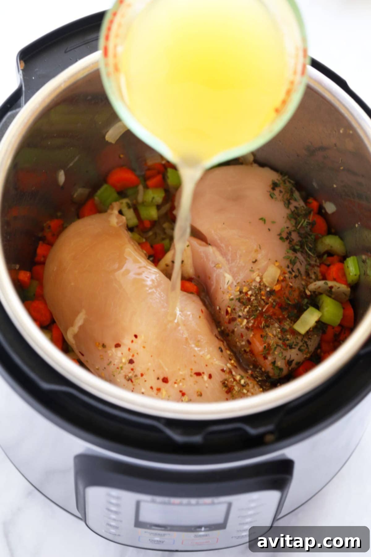 Instant Pot chicken noodle soup with shredded chicken, egg noodles, and vegetables in a rich broth.