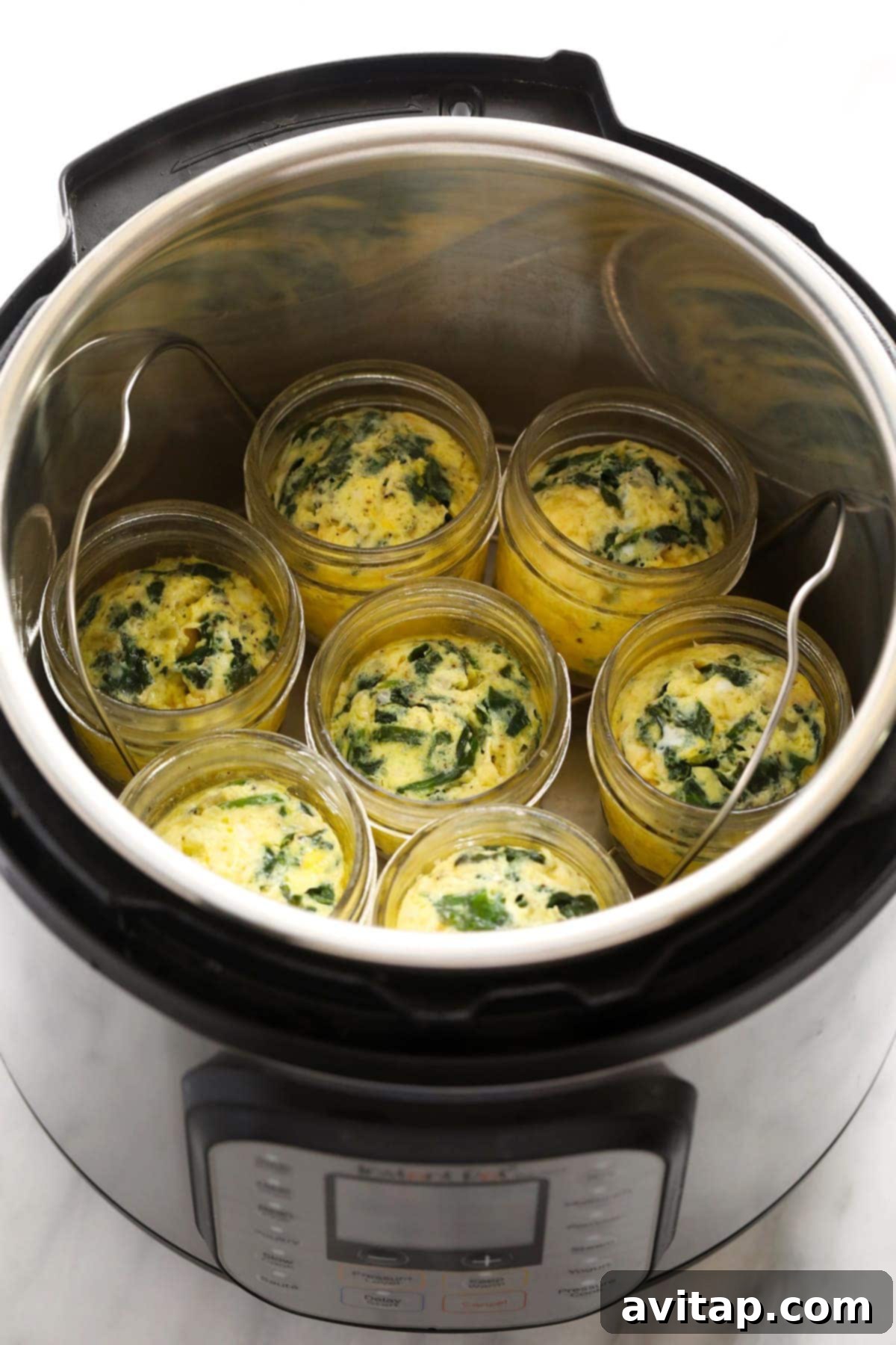 Fluffy Instant Pot Egg Bites 7 Instant Pot egg bites in glass jars, perfect for individual servings and meal prep.