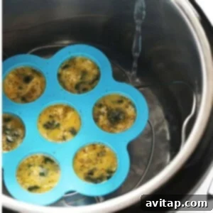 An air fryer filled with eggs in a muffin tin.