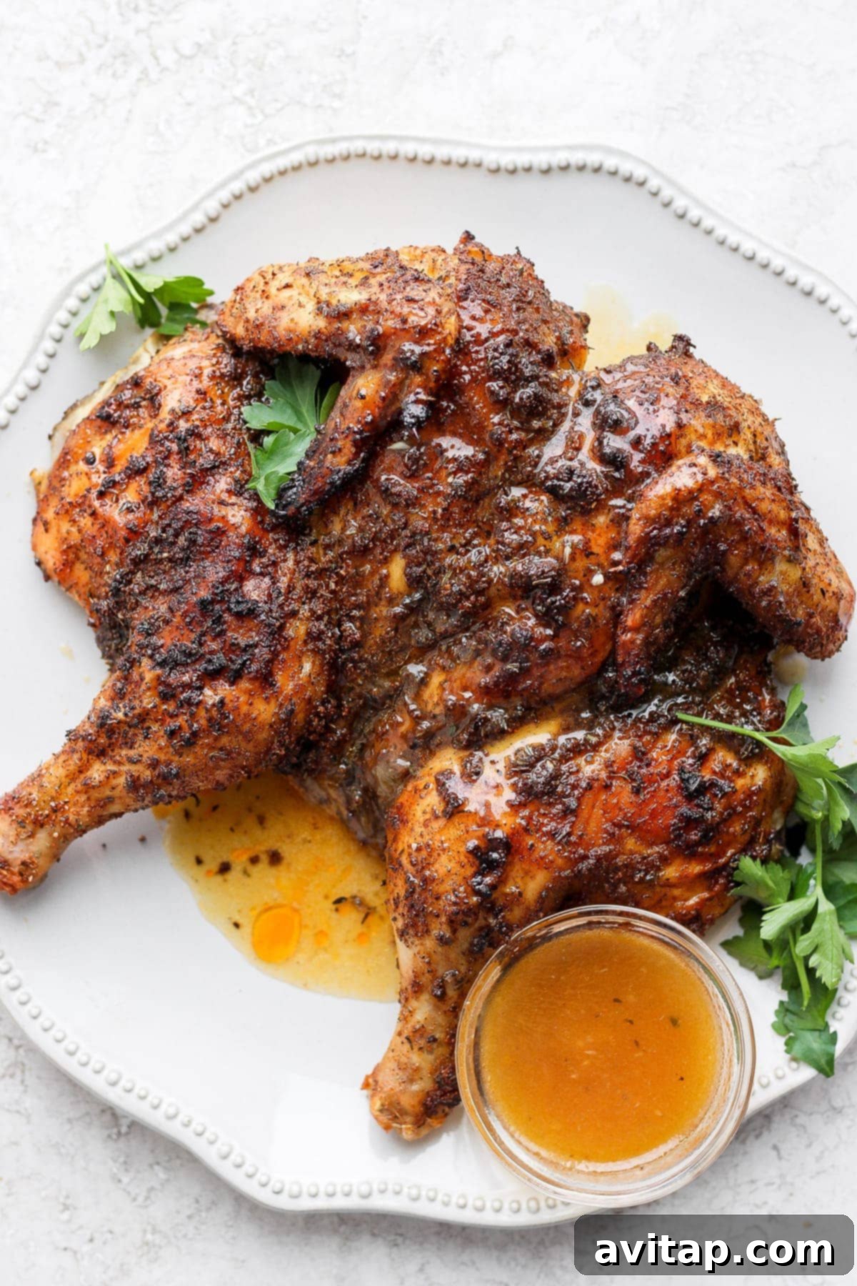 Carved spatchcock chicken elegantly arranged on a platter, ready to be served and enjoyed with its rich pan gravy.