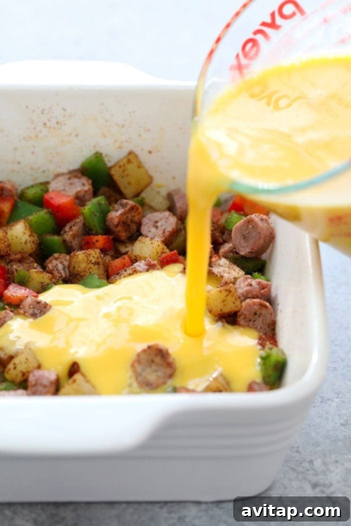 Chicken fajita breakfast casserole ingredients mixed in a baking dish, ready for egg mixture