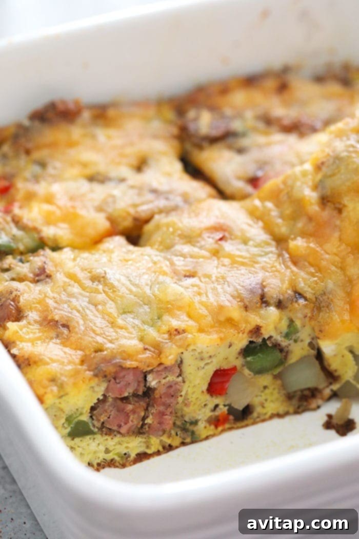 Sliced chicken fajita breakfast casserole, showing the layers of eggs, sausage, and vegetables