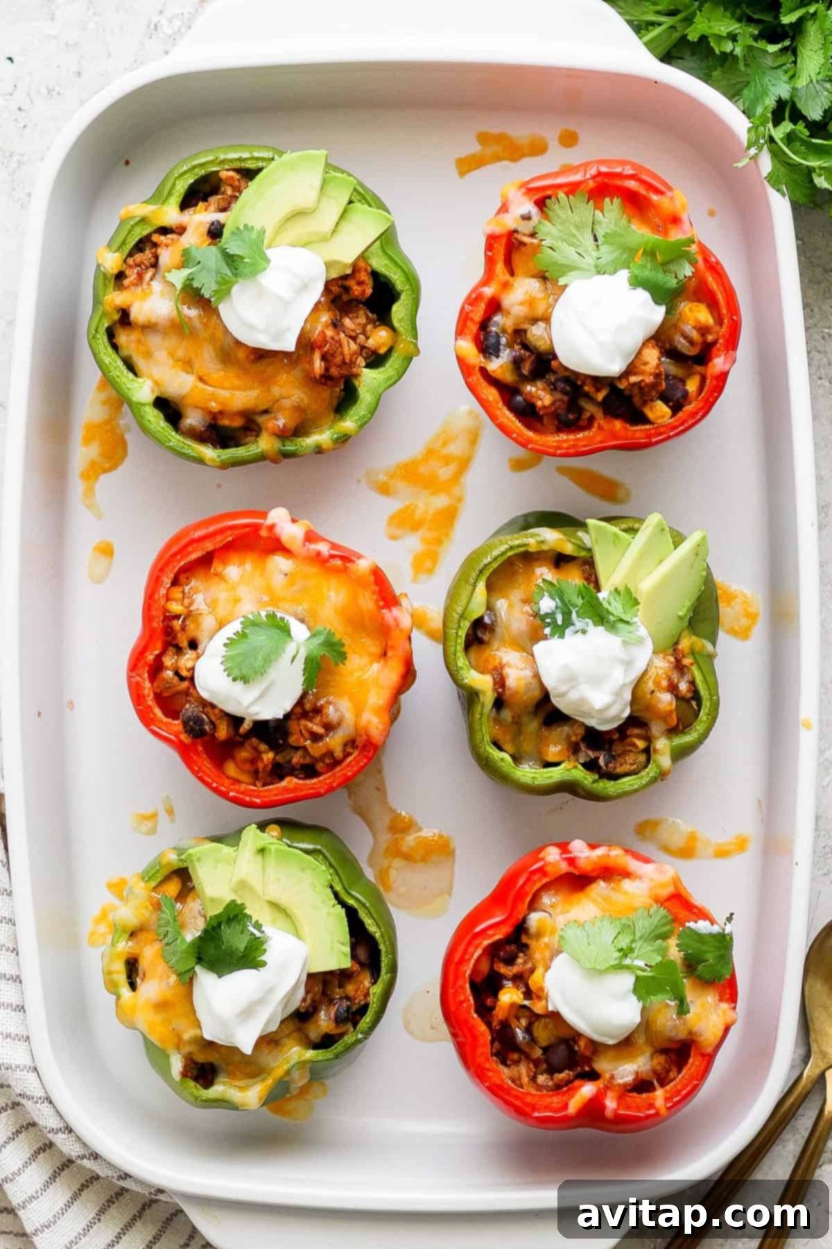 Fiesta-Filled Bell Peppers 2 Beautifully cooked Mexican stuffed peppers, golden brown and topped with melted cheese, ready to be served.